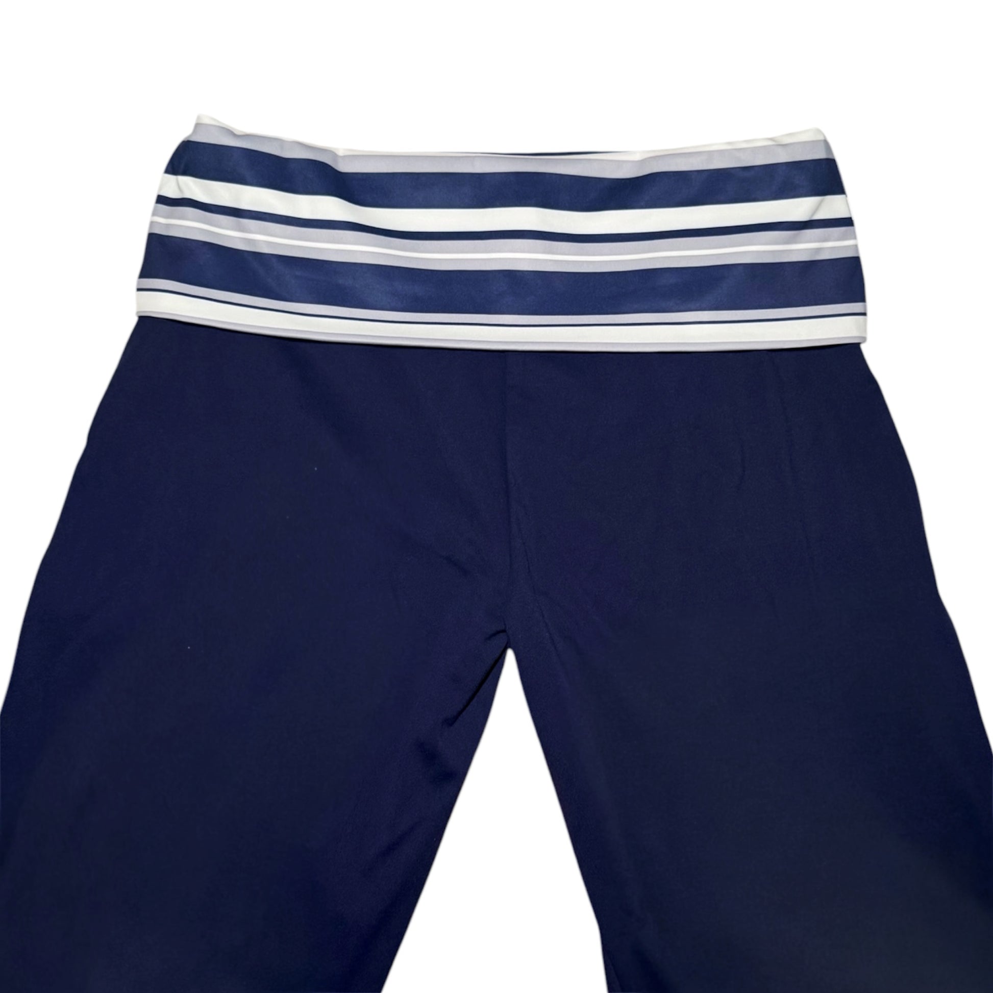 Navy blue leggings with a wide elastic waistband featuring horizontal navy, white, and light gray stripes, shown against a plain white background.